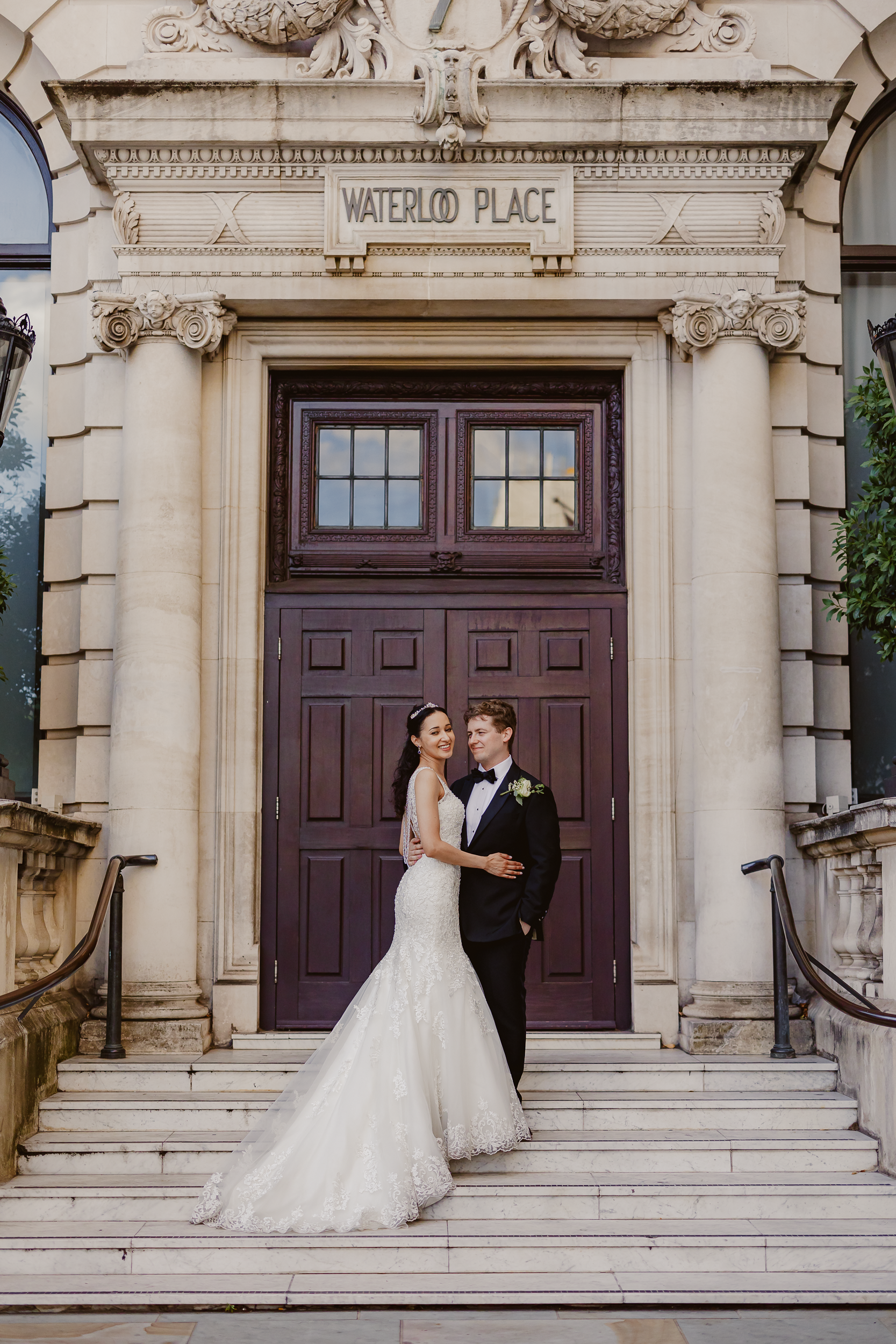 Bride and Groom Embracing on the Steps of Waterloo Place 18 Bride and groom holding each other lovingly on the steps of Waterloo Place outdoors