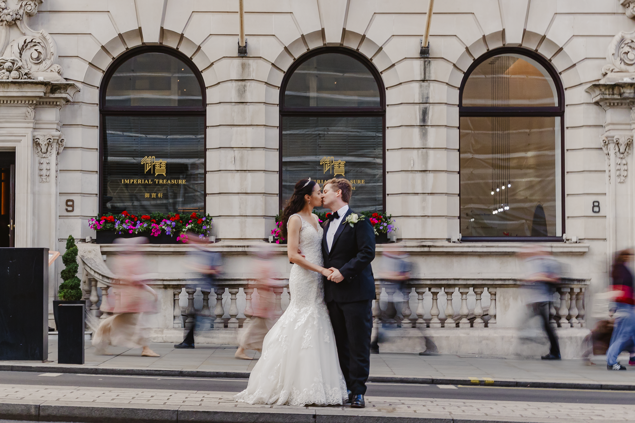 London Wedding Photography | Debbie and David’s Piccadilly Wedding 4 London Wedding Photography Bride and Groom in Motion Amidst City Traffic and groom standing in the middle of a street with fast-moving cars passing by during wedding day photoshoot