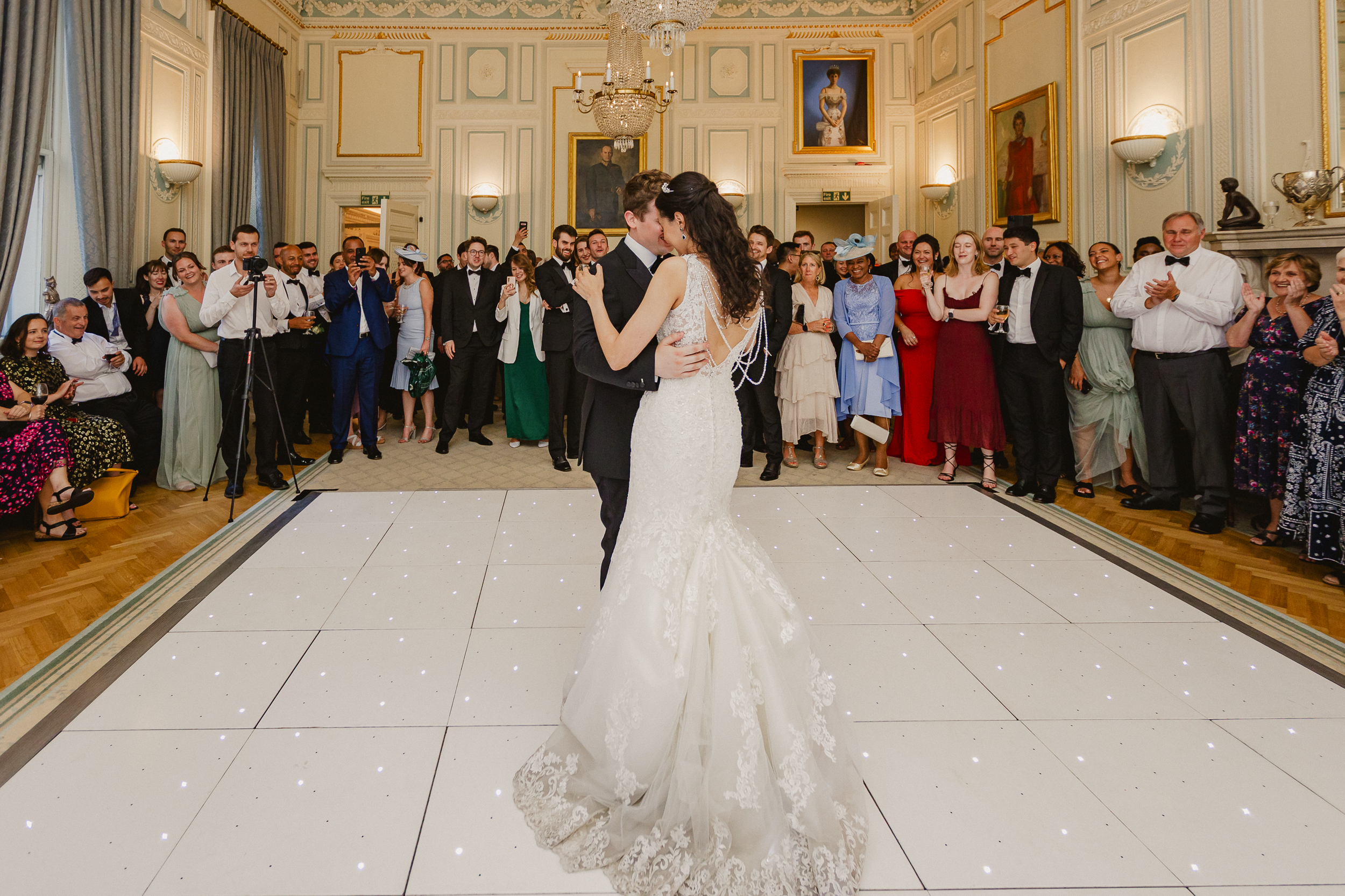 Bride and Groom's First Dance at the In and Out Club 20 Bride and groom sharing their first dance while guests watch at the In and Out Club wedding reception